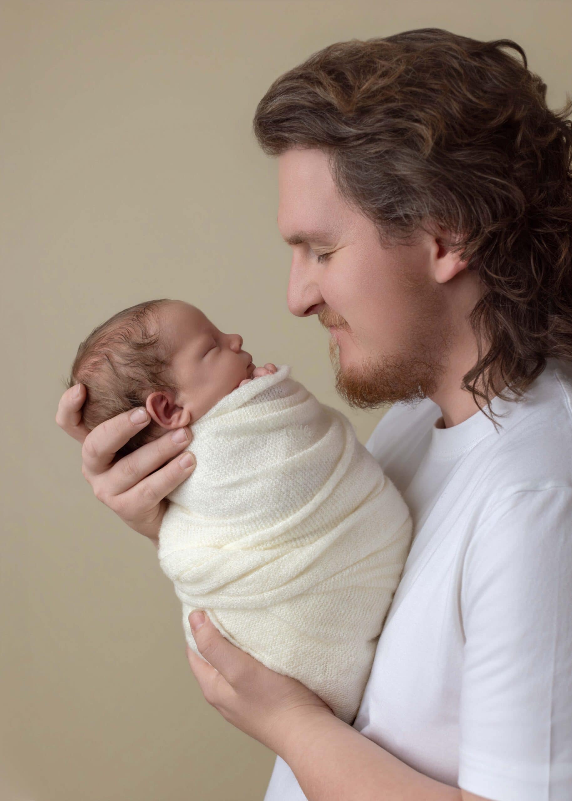 Dad holds his newborn baby in Edmonton for newborn family photography